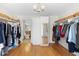 Open closet featuring wood floors, shelving, clothes racks, and a mirror to the left at 1062 Golf View Estates Dr, Orange City, FL 32763