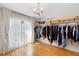Bright walk-in closet featuring custom closet organizers and hardwood floors at 1062 Golf View Estates Dr, Orange City, FL 32763