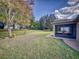 Large backyard with a beautiful, well maintained lawn and view of screened lanai at 107 Gladesdown Ct, Deland, FL 32724