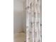 Bright bathroom features a shower/tub combo with decorative floral shower curtain at 107 Gladesdown Ct, Deland, FL 32724