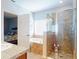 Bright bathroom with tub, separate glass shower, and access to the bedroom at 107 Gladesdown Ct, Deland, FL 32724