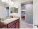 Bright bathroom features a double vanity with granite countertop, and decorative mirror at 107 Gladesdown Ct, Deland, FL 32724
