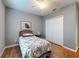 This bedroom features hardwood floors, a ceiling fan, and a window allowing natural light at 107 Gladesdown Ct, Deland, FL 32724