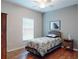 This bedroom features hardwood floors, a ceiling fan, and a window allowing natural light at 107 Gladesdown Ct, Deland, FL 32724