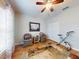 Comfortable bedroom with wood floors, a ceiling fan, and functional exercise equipment at 107 Gladesdown Ct, Deland, FL 32724