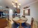 Charming dining area featuring a decorative window treatment and an elegant chandelier at 107 Gladesdown Ct, Deland, FL 32724