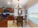 Sunlit dining area with a view to the kitchen and a large window allowing natural light at 107 Gladesdown Ct, Deland, FL 32724