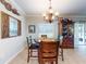 Bright dining area featuring a charming chandelier and a decorative hutch for added storage at 107 Gladesdown Ct, Deland, FL 32724