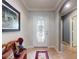 Inviting entryway featuring a decorative glass door and a charming wooden bench with decorative pillow at 107 Gladesdown Ct, Deland, FL 32724