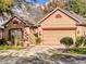 Charming single-Gathering home featuring a two-car garage and mature landscaping at 107 Gladesdown Ct, Deland, FL 32724