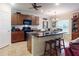 Kitchen featuring rich wood cabinets, a center island with barstool seating and black granite countertops at 107 Gladesdown Ct, Deland, FL 32724