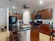 Kitchen featuring dark cabinets, granite countertops, island with seating, and stainless steel refrigerator at 107 Gladesdown Ct, Deland, FL 32724