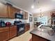 Kitchen featuring rich wood cabinets, a black gas range, and a breakfast nook for casual dining at 107 Gladesdown Ct, Deland, FL 32724