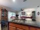 View of kitchen island with stainless sink and dishwasher with a view to the living room at 107 Gladesdown Ct, Deland, FL 32724