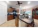 Kitchen featuring rich wood cabinets, a center island with barstool seating and black granite countertops at 107 Gladesdown Ct, Deland, FL 32724