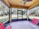 Screened lanai featuring a ceiling fan and views of the backyard at 107 Gladesdown Ct, Deland, FL 32724