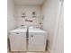 This laundry room features a washer, dryer and shelving for storage at 107 Gladesdown Ct, Deland, FL 32724