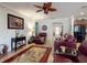 Living room with ceiling fan, tile flooring, and an arched doorway to the main entrance and hallway at 107 Gladesdown Ct, Deland, FL 32724