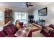 Inviting living room with a view to the screened lanai through sliding glass doors at 107 Gladesdown Ct, Deland, FL 32724