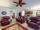Open-concept living space featuring tile flooring, leather seating, and a seamless flow to the kitchen and dining area at 107 Gladesdown Ct, Deland, FL 32724