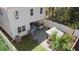 Aerial view of a backyard, featuring a custom outdoor kitchen, patio seating, and privacy fence at 1088 Happy Forest Loop, Deland, FL 32720