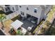 Aerial view of a backyard oasis, featuring a custom outdoor kitchen, lounge area, and white vinyl privacy fence at 1088 Happy Forest Loop, Deland, FL 32720
