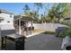 Entertain in style with an outdoor kitchen bar, grill, and spacious patio surrounded by a pristine white fence at 1088 Happy Forest Loop, Deland, FL 32720