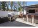 This covered outdoor kitchen features a grill, a wood counter, and seating for backyard entertaining at 1088 Happy Forest Loop, Deland, FL 32720