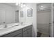 Bright bathroom featuring double sinks and a shower/toilet area separated by a door at 1088 Happy Forest Loop, Deland, FL 32720
