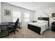 Cozy bedroom with a dark bed, desk, and a hockey theme at 1088 Happy Forest Loop, Deland, FL 32720