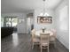 Inviting dining area adjacent to the living room with neutral tones and a view to the outside at 1088 Happy Forest Loop, Deland, FL 32720