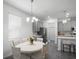 Cozy dining space next to kitchen featuring a round table, modern lighting, and updated appliances at 1088 Happy Forest Loop, Deland, FL 32720