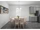 Bright dining area with a round table, seating for four, and a modern chandelier at 1088 Happy Forest Loop, Deland, FL 32720
