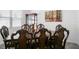 Elegant dining room featuring a dark wood table, ornate chairs, and a charming curio cabinet at 1088 Happy Forest Loop, Deland, FL 32720