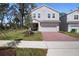 Charming two-story home boasting a well-manicured lawn, brick driveway, and an attached two-car garage at 1088 Happy Forest Loop, Deland, FL 32720