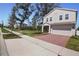 A beautiful, two-story home with a well-maintained lawn, brick driveway, and attached two-car garage at 1088 Happy Forest Loop, Deland, FL 32720