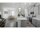 Open-concept kitchen with gray cabinets, white countertops, and an island with seating at 1088 Happy Forest Loop, Deland, FL 32720