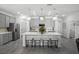 Modern kitchen with a large center island, pendant lighting, and stainless steel appliances at 1088 Happy Forest Loop, Deland, FL 32720