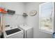 Laundry room with a washing machine, dryer, shelving and a window at 1088 Happy Forest Loop, Deland, FL 32720