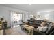 Comfortable living room with a large sectional sofa and sliding glass doors to the outdoor patio at 1088 Happy Forest Loop, Deland, FL 32720