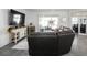 Living room featuring a large sectional sofa, tv, and view of the patio at 1088 Happy Forest Loop, Deland, FL 32720
