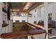 This outdoor kitchen bar features a gorgeous wood counter, three seats, and a built in TV at 1088 Happy Forest Loop, Deland, FL 32720
