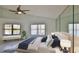 Bedroom featuring a large bed, dual windows, and mirrored wall at 111 Brown Crane Ct, Daytona Beach, FL 32119