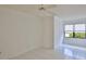 Simple, light-filled bedroom with large window and neutral flooring at 111 Brown Crane Ct, Daytona Beach, FL 32119