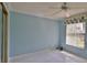 Bedroom with blue walls, white tile flooring and a ceiling fan at 111 Brown Crane Ct, Daytona Beach, FL 32119