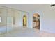Spacious bedroom with tile floors, mirrored walls, and adjoining bathroom at 111 Brown Crane Ct, Daytona Beach, FL 32119