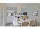 Elegant dining room features a modern chandelier, fireplace, and seamless flow to the living area at 111 Brown Crane Ct, Daytona Beach, FL 32119