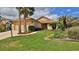 Charming single-Gathering home featuring a well-manicured lawn, mature palm trees, and a two-car garage at 111 Brown Crane Ct, Daytona Beach, FL 32119