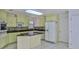 Spacious kitchen with a center island, tiled flooring, and modern appliances at 111 Brown Crane Ct, Daytona Beach, FL 32119