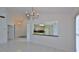 Bright, open-concept living room showcases tile floors and a pass-through view to kitchen at 111 Brown Crane Ct, Daytona Beach, FL 32119